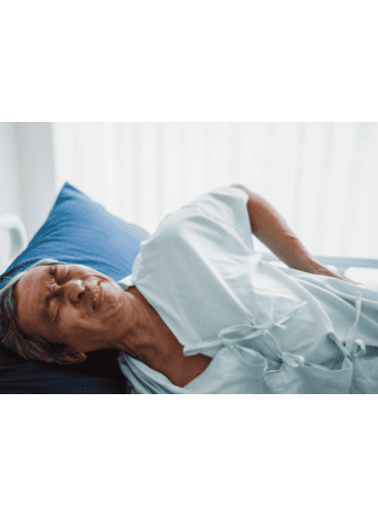 A man clutching his lower back in pain 